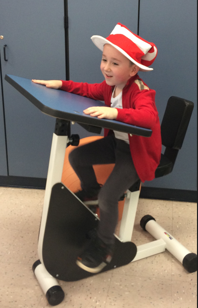 Image of student in pedal desk